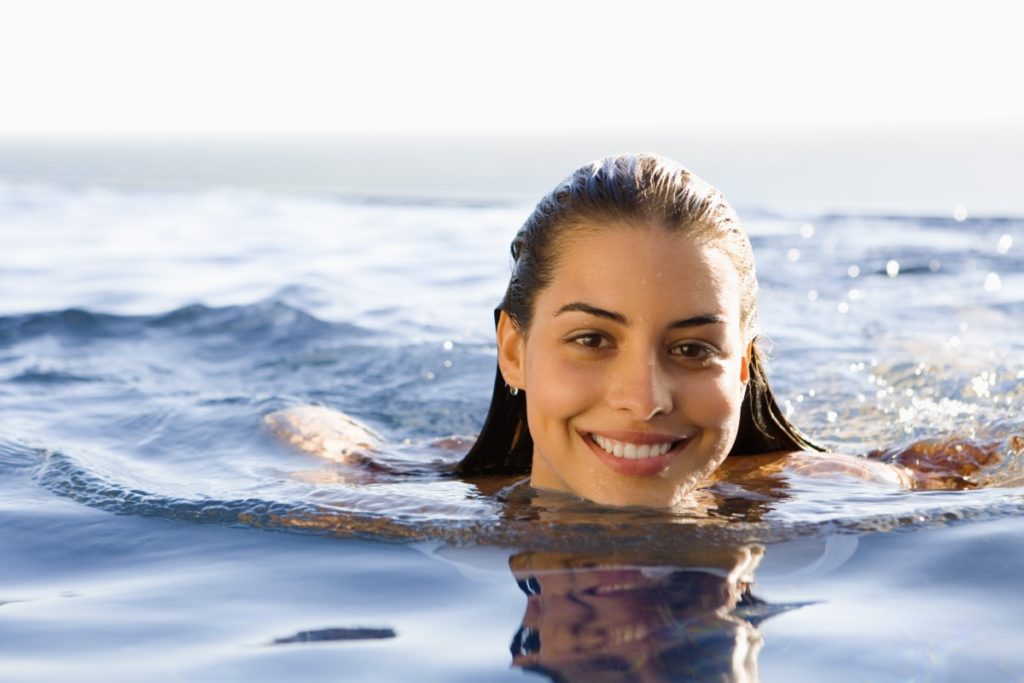 Woman swimming in infinity pool
